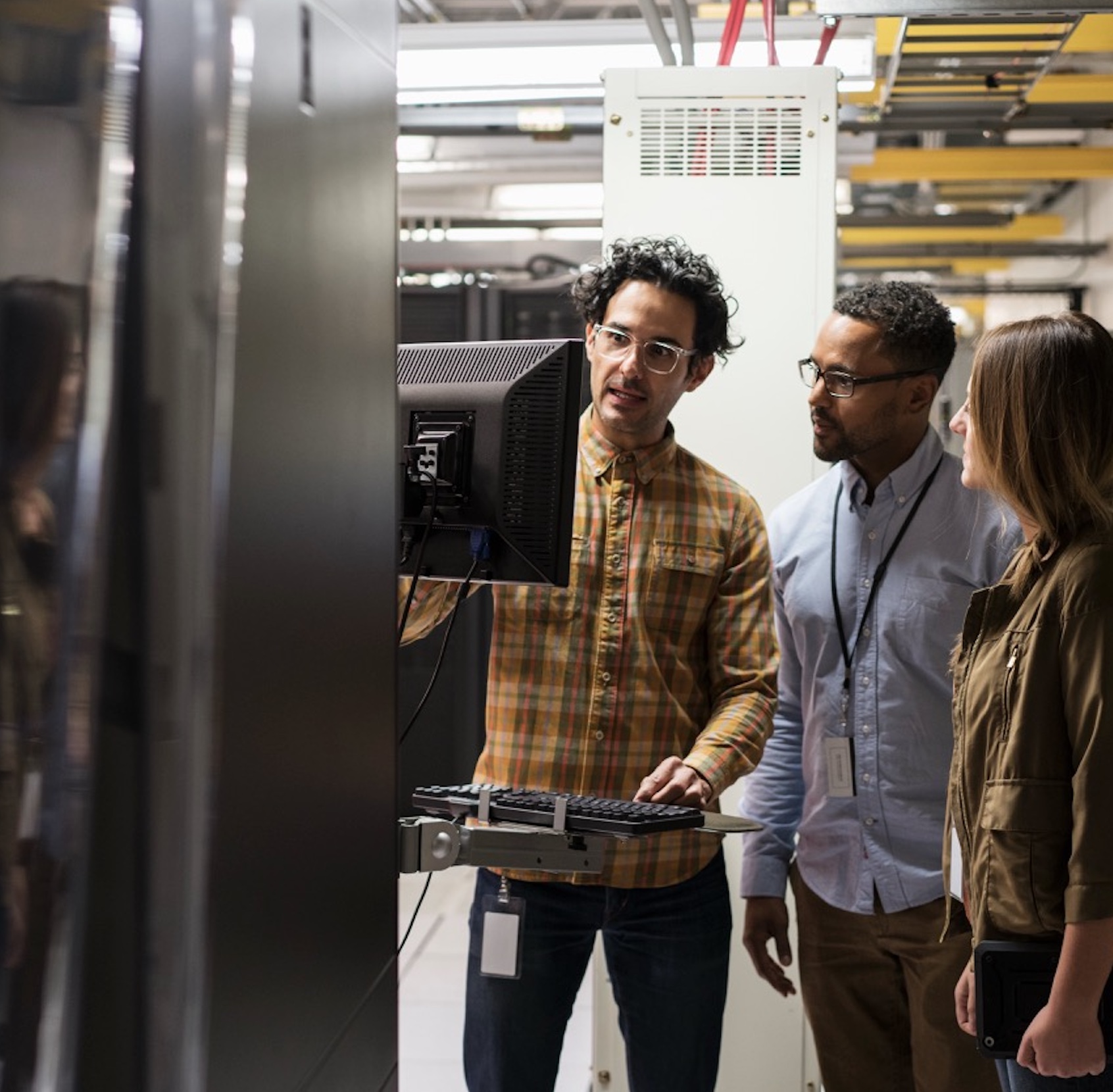 Business technology team reviewing backup and recovery status in a bright operations workspace