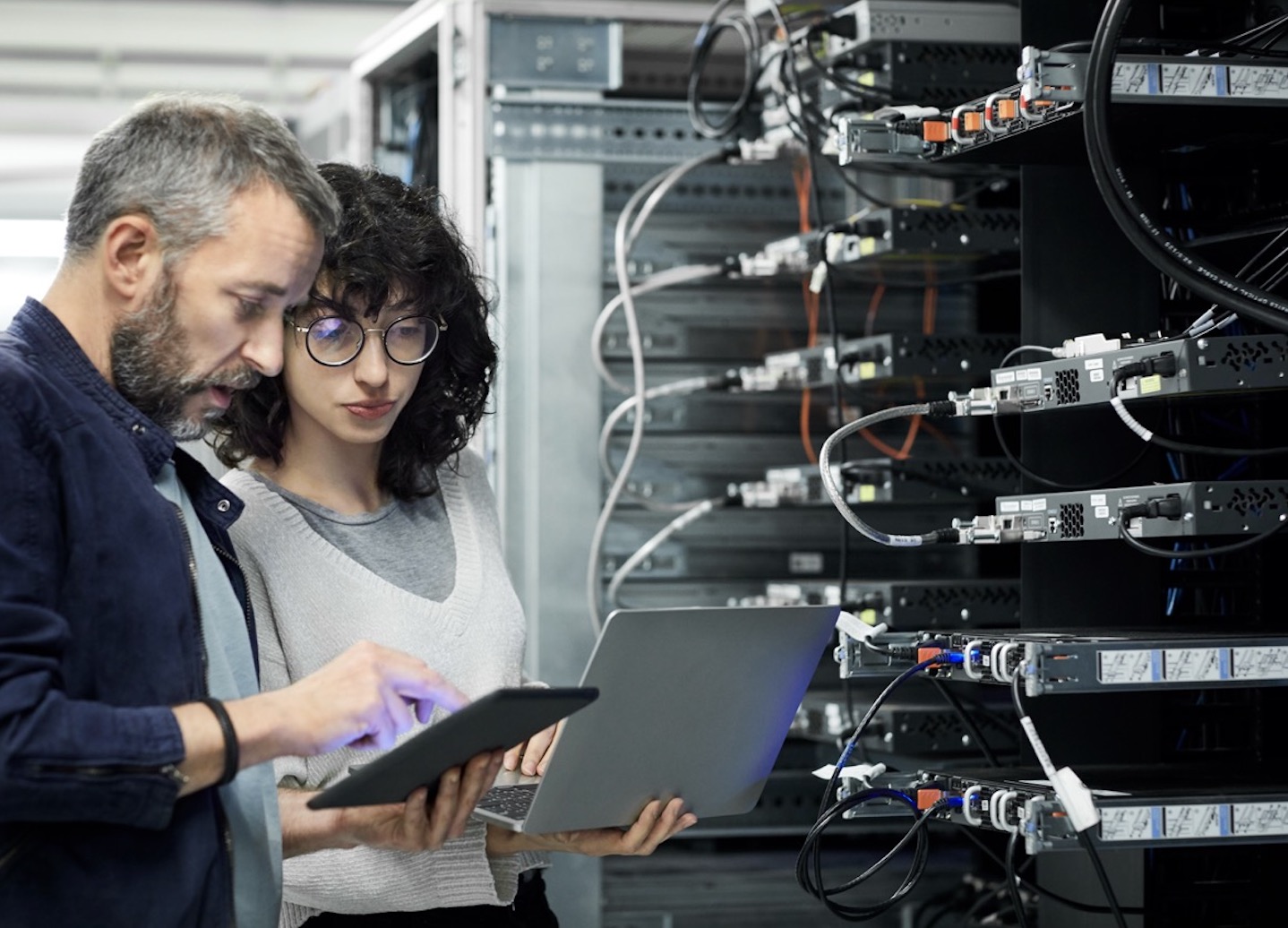Network operations professional reviewing infrastructure connectivity from a modern workspace