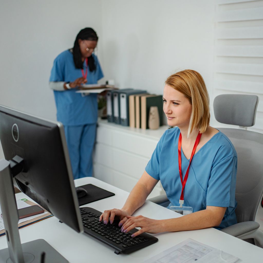Healthcare staff working at computers in a clinical office
